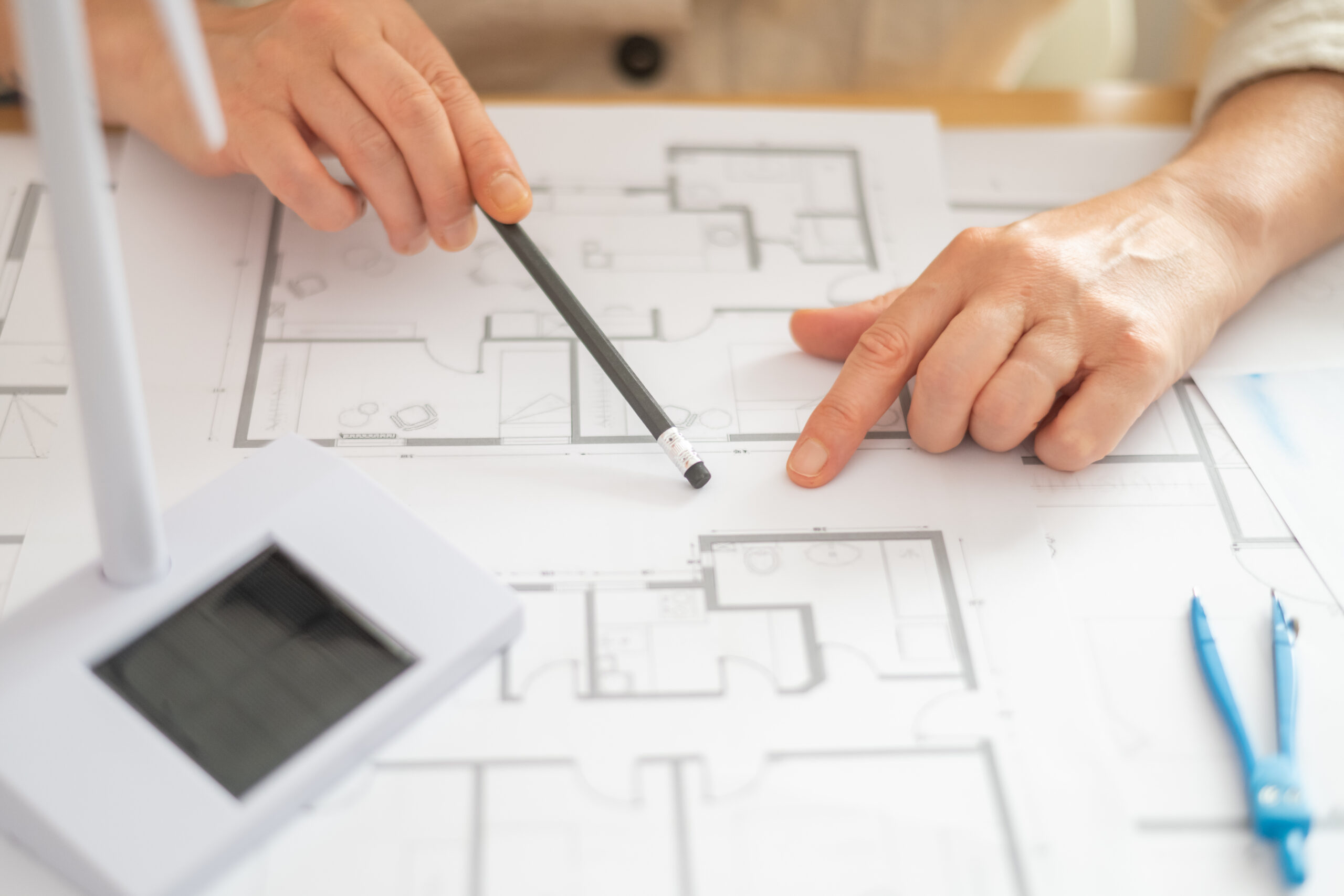 Engineers analyzing blueprints for a building project